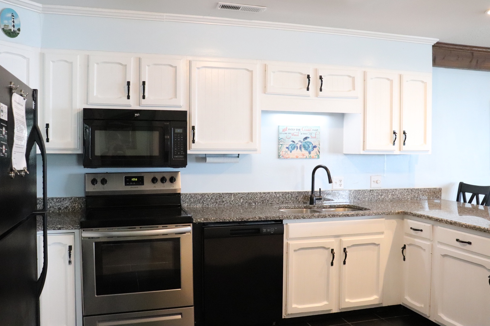 Your fully equipped kitchen with modern appliances, granite counters, and coastal charm invites you to whip up fresh meals during your stay.