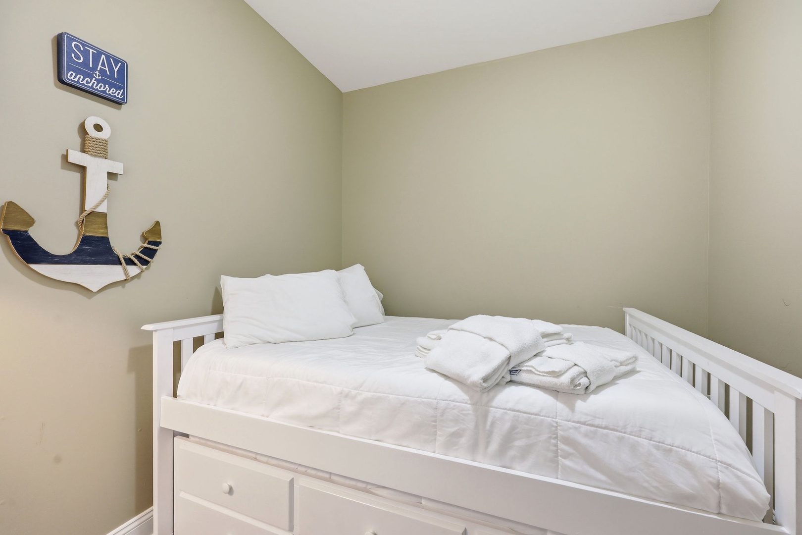 Drift off in this cozy nautical-themed retreat with crisp white linens and charming coastal décor welcoming you home after a day of adventure.