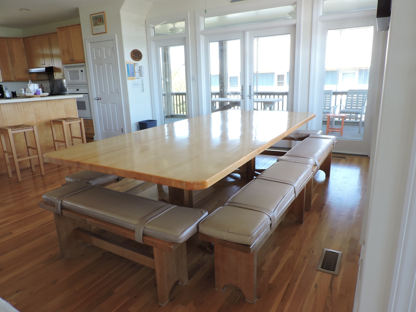 Gather around this spacious dining table where your group can share meals and make memories together in this bright, open-plan space.