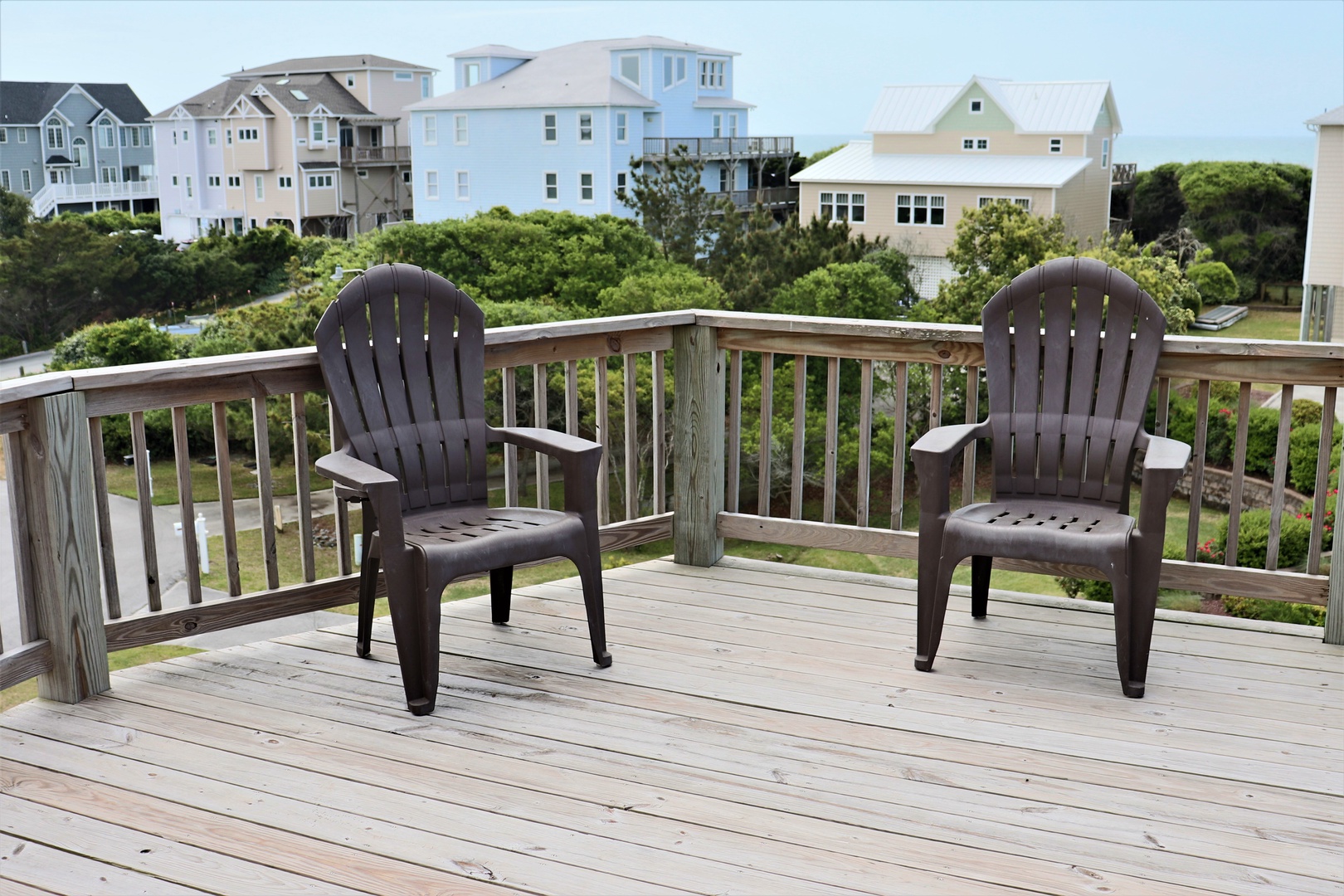Relax in comfortable Adirondack chairs on your private deck, taking in peaceful neighborhood views and ocean breezes.