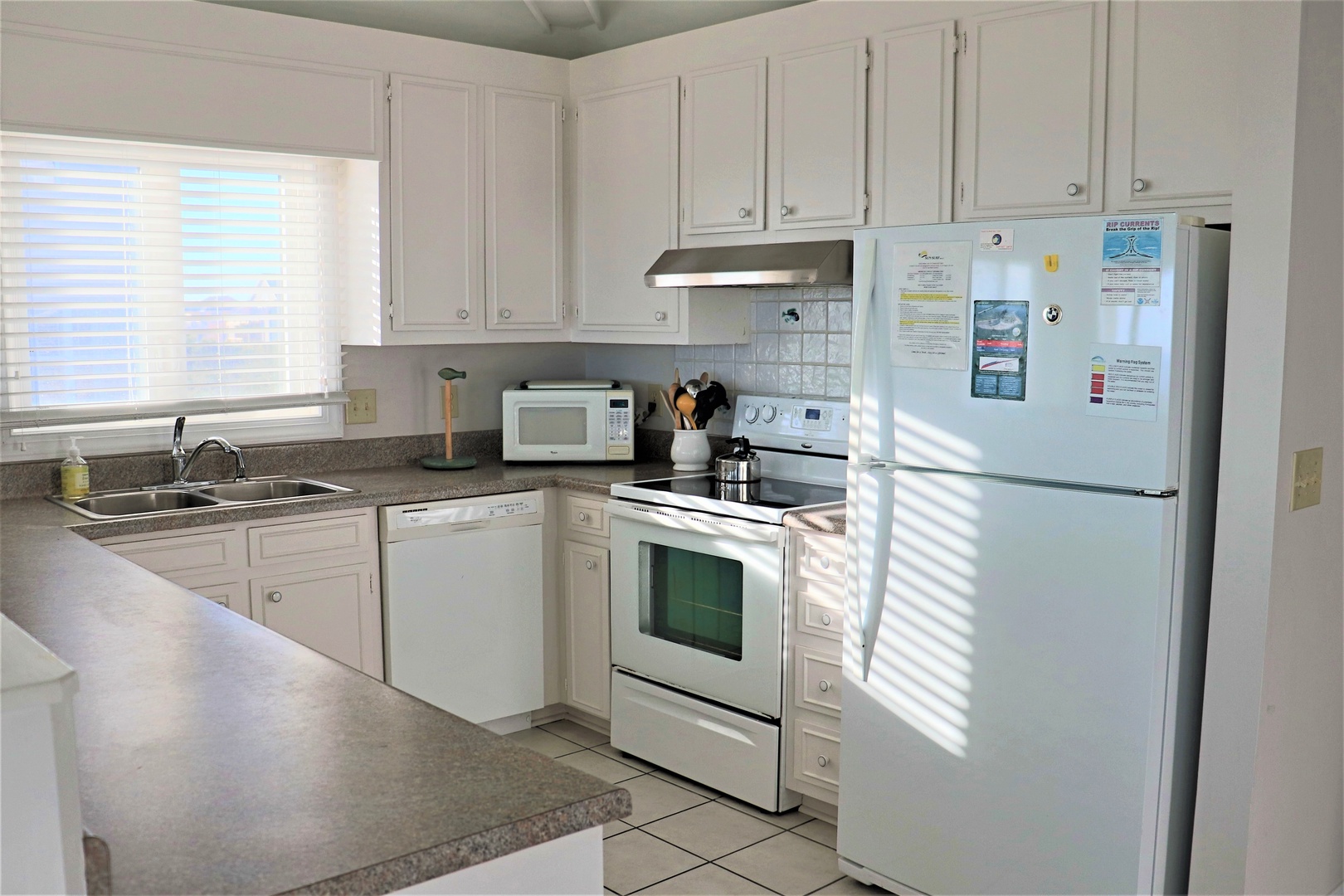 Cook your favorite meals in this bright, fully-equipped kitchen with modern appliances and ample counter space for all your culinary adventures.
