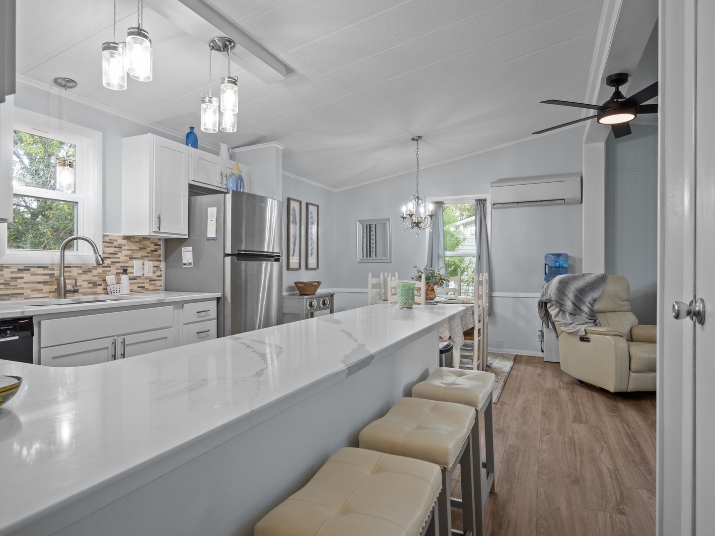 Your bright, open-concept kitchen flows seamlessly into the living area, featuring gleaming countertops and modern appliances perfect for cooking together.