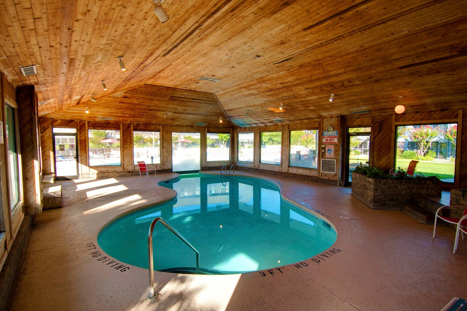 Dive into your private indoor pool sanctuary, where warm wood ceilings and panoramic windows create a tranquil escape.