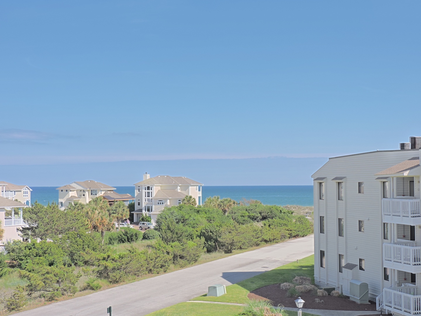 Coastal community with ocean views and neighboring vacation homes visible from the property area.