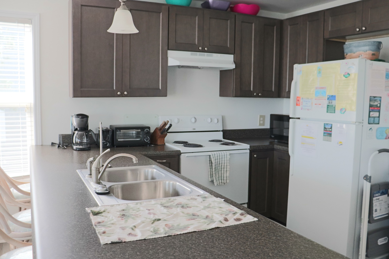 Your fully equipped kitchen awaits with modern appliances and granite counters for preparing memorable meals during your stay.