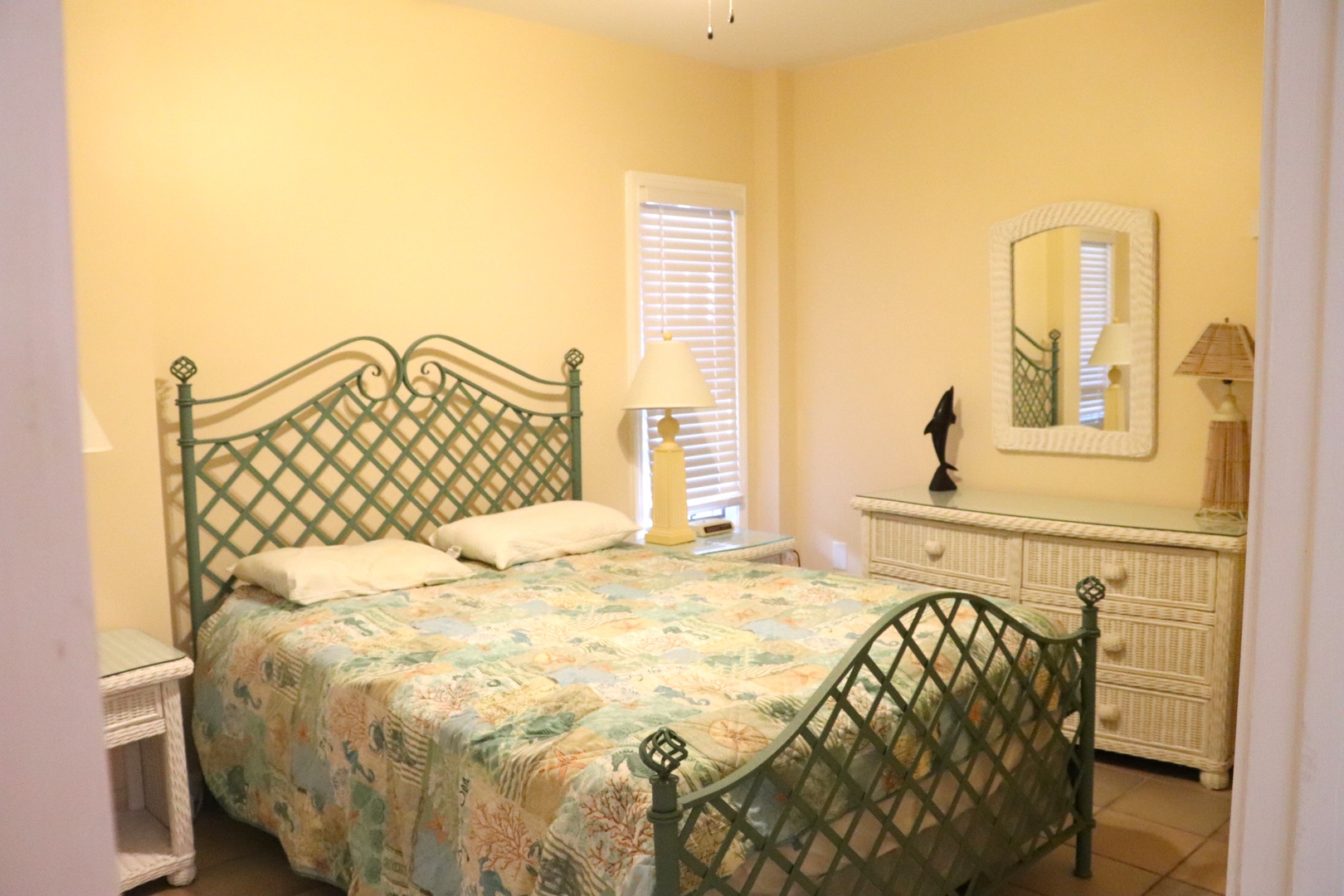 Drift off in your cheerful bedroom with coastal-themed bedding and tropical touches that make every morning feel like paradise.