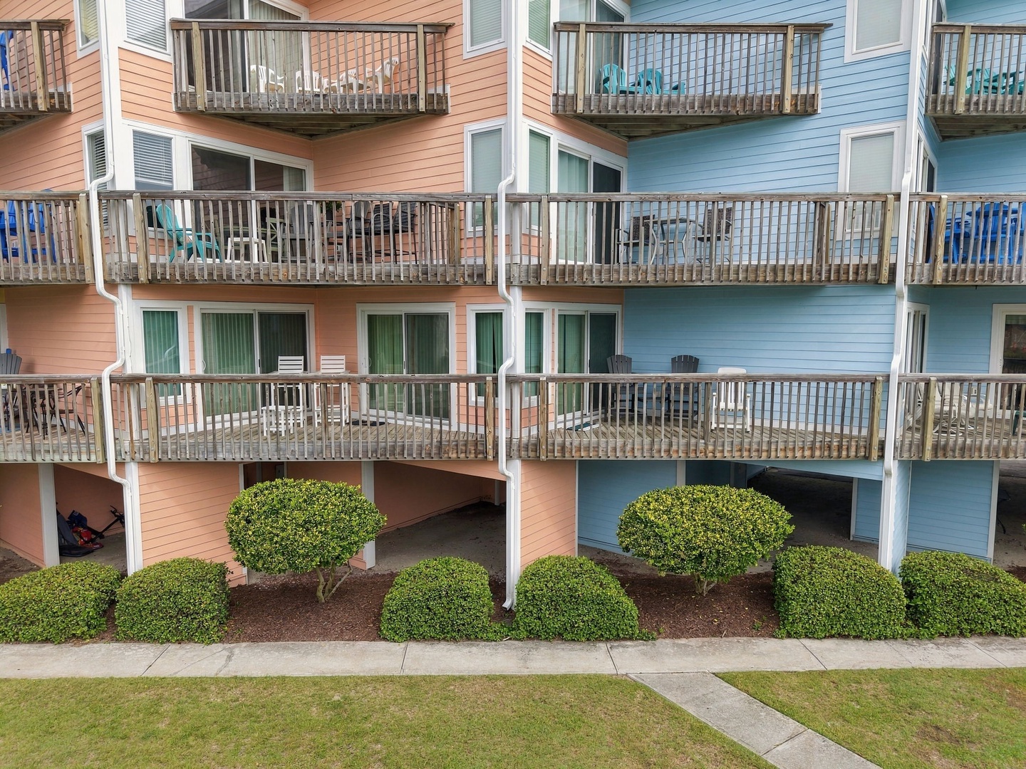 Coastal living at its finest—colorful beach-style units with private balconies, manicured landscaping, and easy access to the shore. Your oceanside escape starts here.