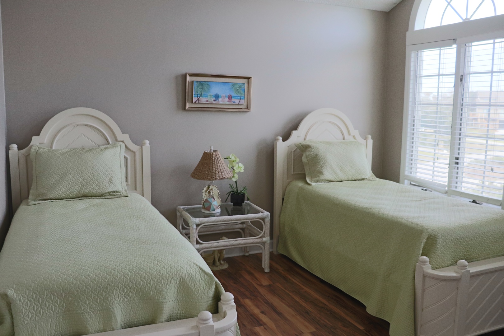 Rest peacefully in your bright twin bedroom with soft green bedding and tranquil decor.