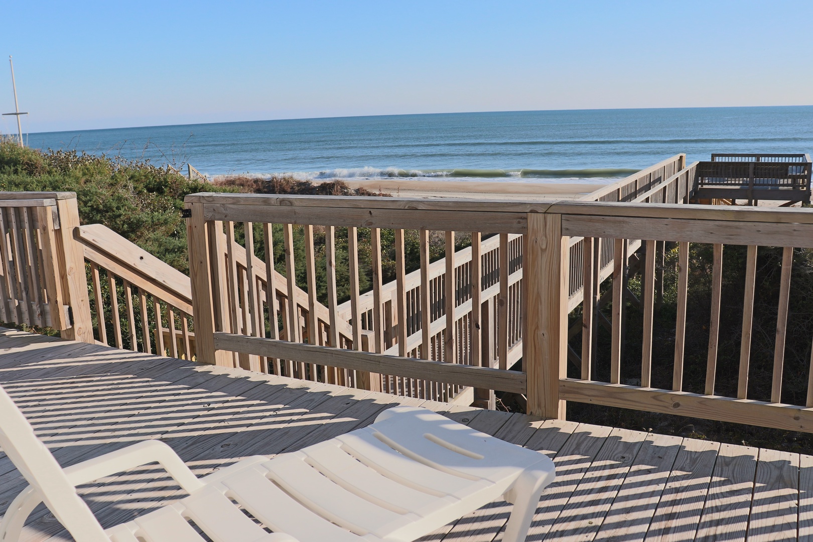 Unwind on your private deck with stunning ocean views and direct beach access just steps away.