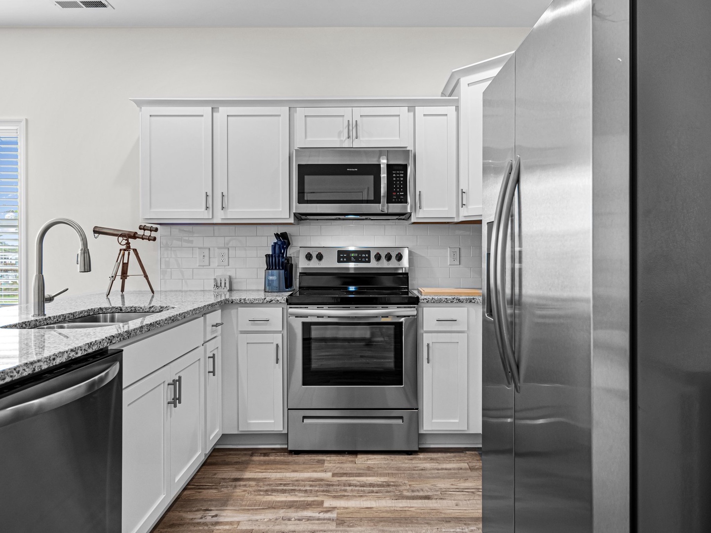 Your fully equipped kitchen features granite counters, stainless steel appliances, and white cabinetry for memorable meal prep.