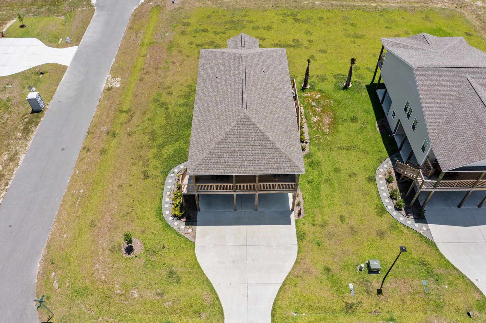 Aerial view of a modern vacation rental property nestled in a quiet residential neighborhood with spacious grounds and convenient parking.