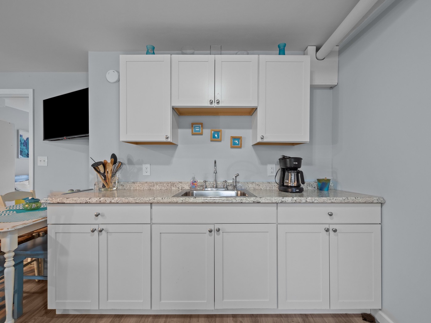 Your well-equipped kitchen awaits with granite counters, white cabinets, and everything you need to prepare meals during your stay.