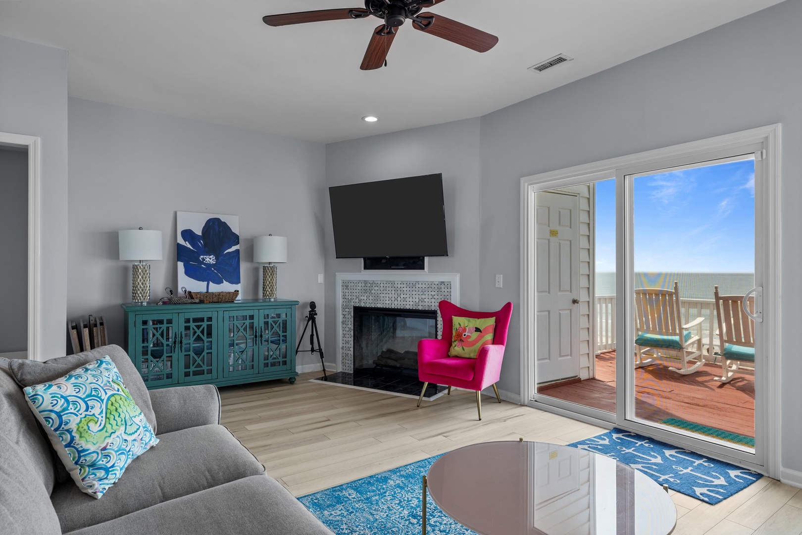 Unwind in your stylish living room with vibrant coastal decor and ocean views. The bright space flows seamlessly to your private balcony.