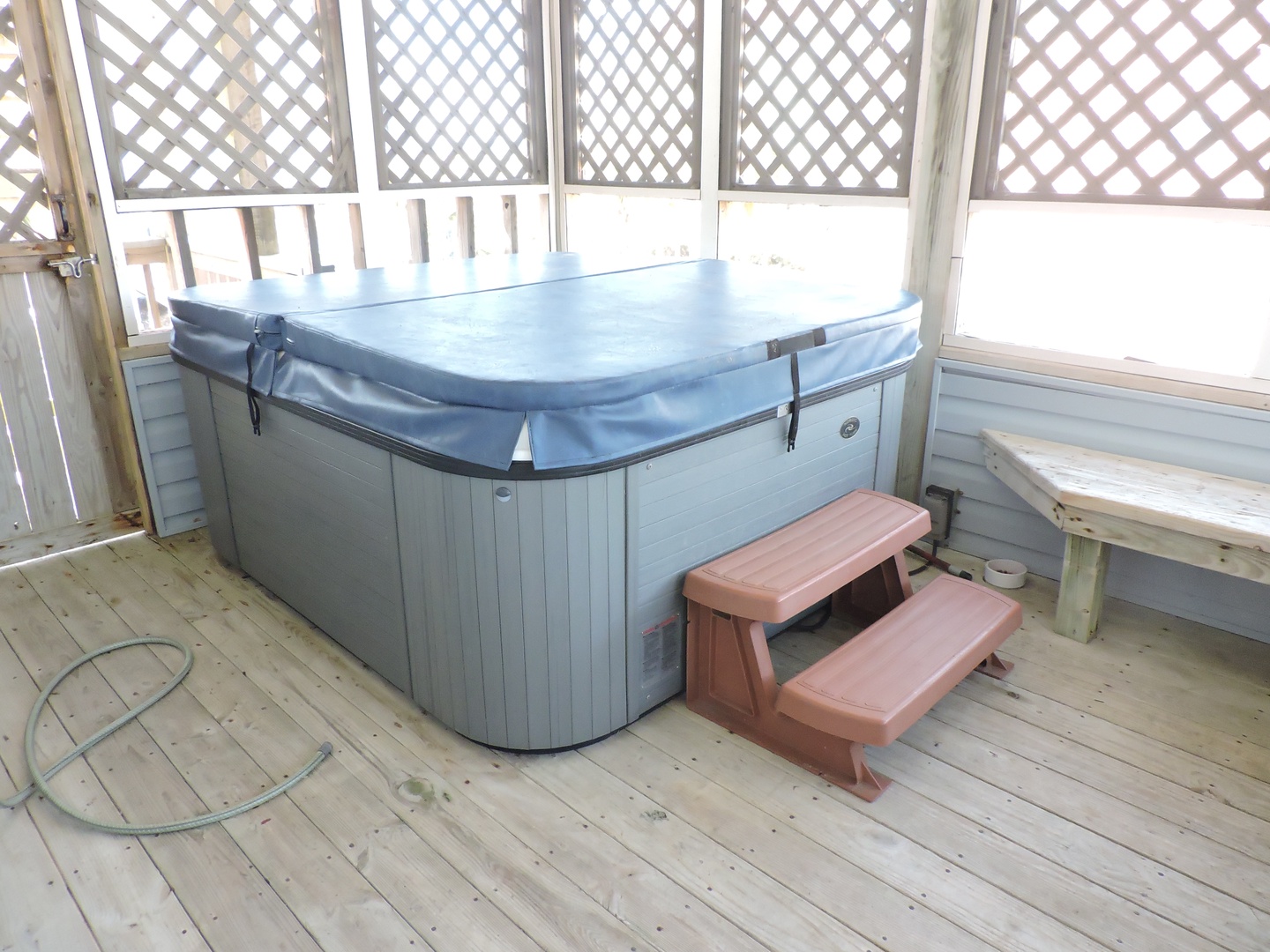 Unwind in your private hot tub on the covered deck, where warm bubbles and peaceful views create the perfect escape.