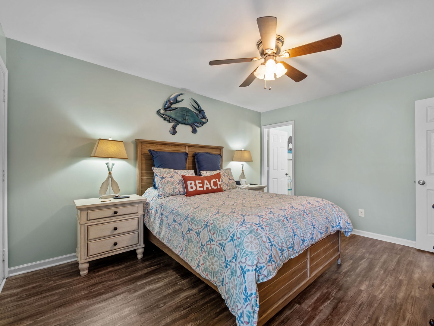 Your coastal-themed bedroom offers peaceful sleep with soft linens, gentle ceiling fan breeze, and charming nautical touches throughout.