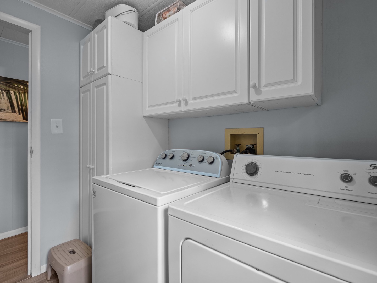 Your private laundry room features full-size washer and dryer with convenient upper cabinets for storage—no more searching for laundromats during your stay.