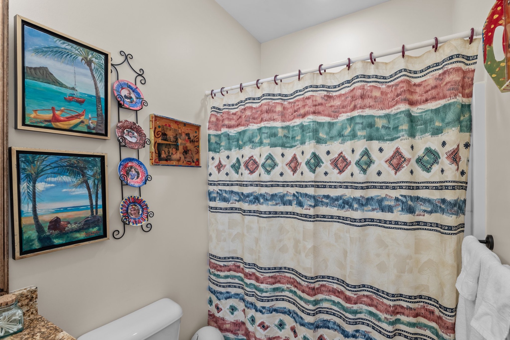Step into your vibrant bathroom featuring tropical artwork and colorful bohemian touches that create a cheerful, artistic atmosphere for your daily routine.