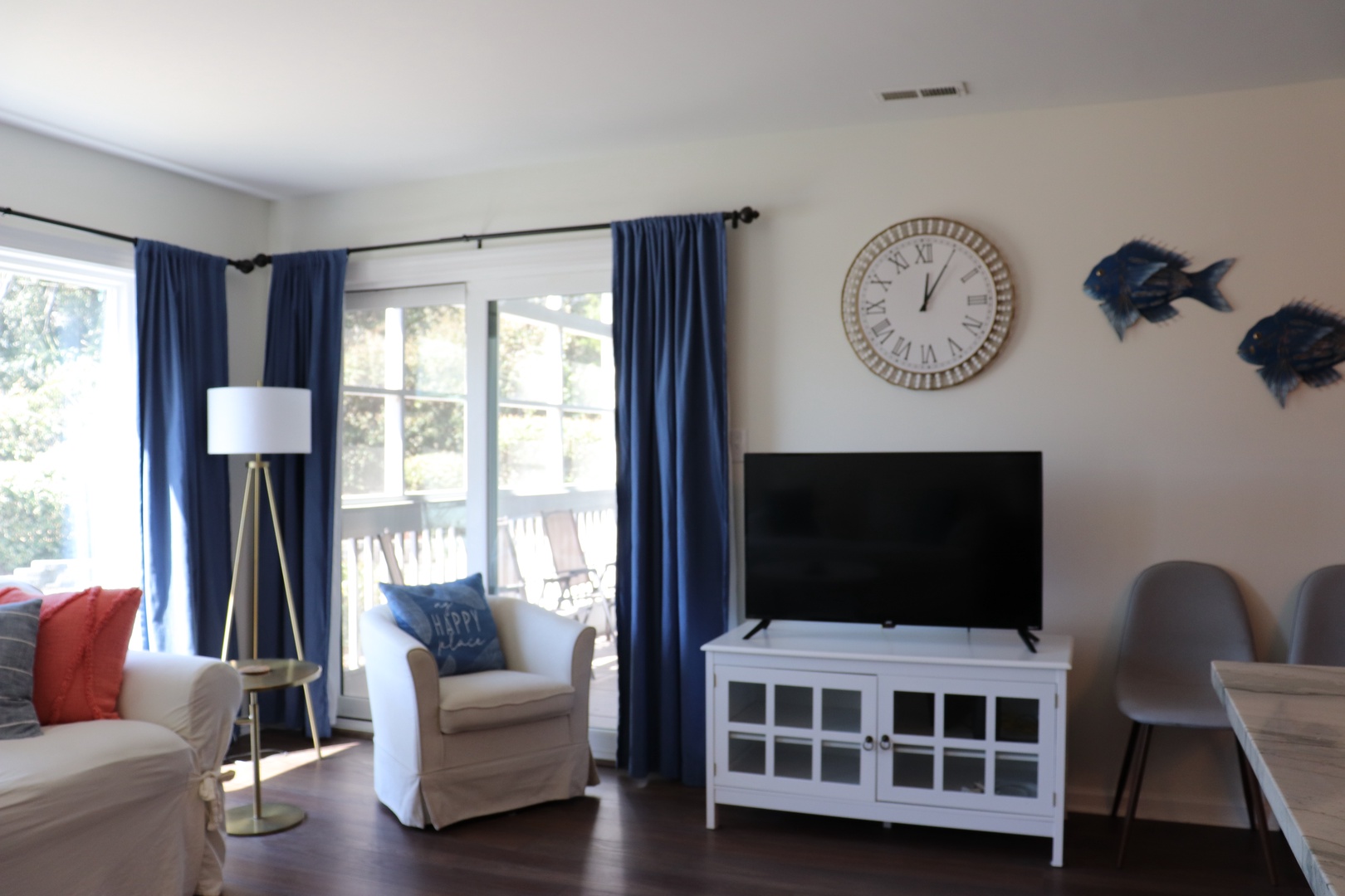 Unwind in your bright living space with comfortable seating, entertainment center, and peaceful balcony access for relaxing moments.