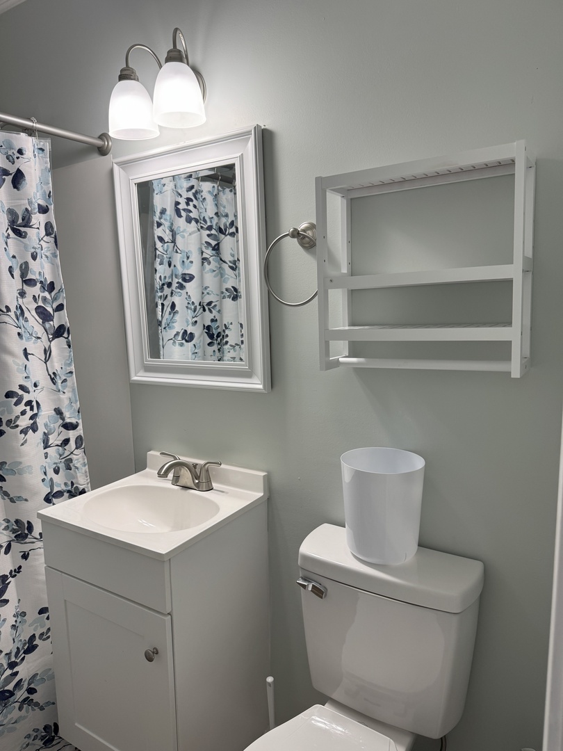 Refresh in your bright, well-appointed bathroom featuring modern fixtures, thoughtful storage, and charming floral accents that add a touch of elegance to your daily routine.