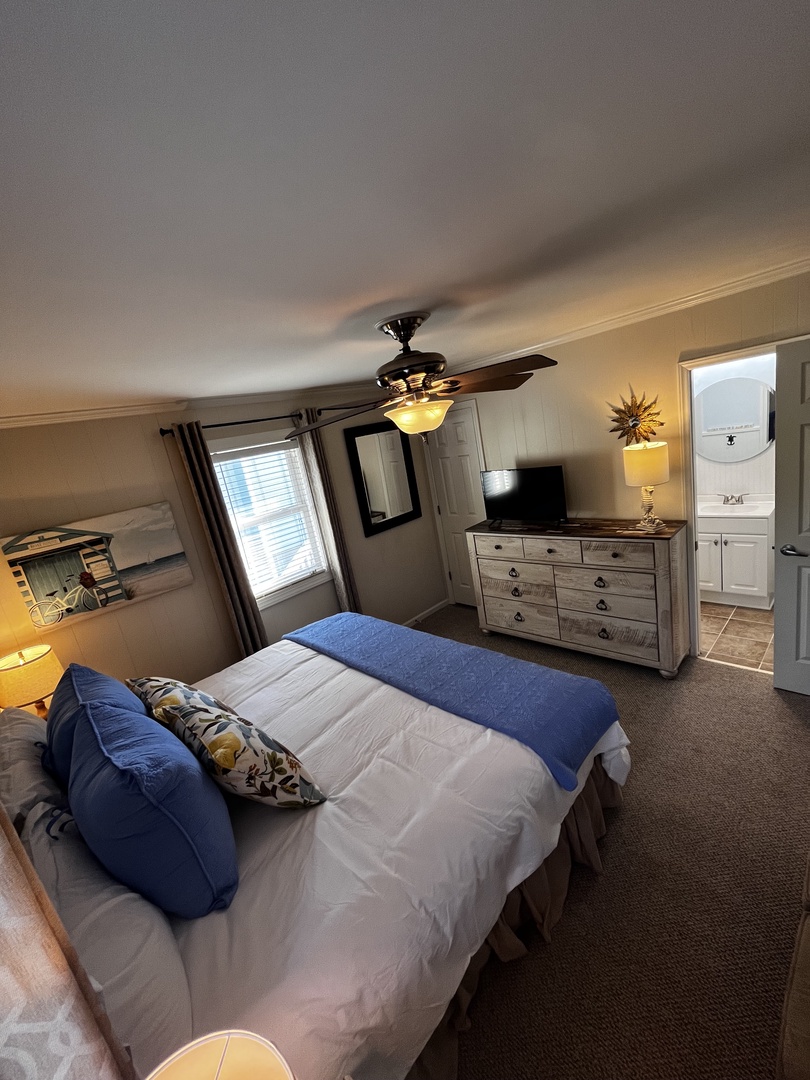 Sink into your cozy retreat with crisp linens and blue accents, where thoughtful touches create the perfect restful sanctuary.