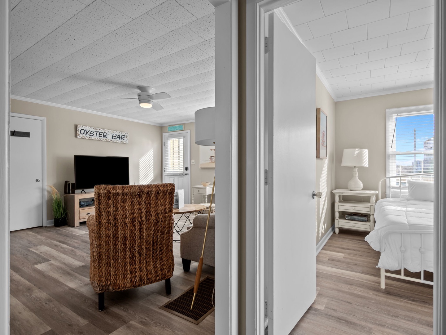 Step into your bright, coastal-inspired retreat where whitewashed ceilings and nautical charm create the perfect seaside escape.