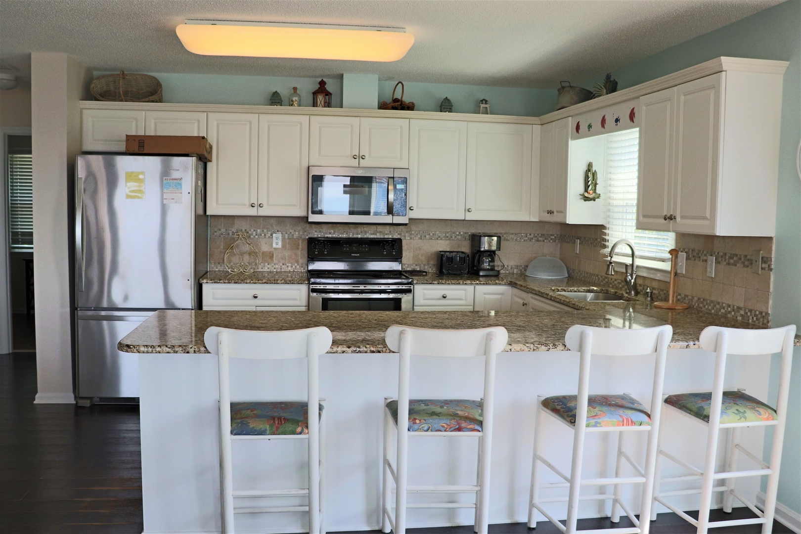 Your fully equipped kitchen awaits with granite counters, stainless appliances, and breakfast bar seating for memorable meals together.