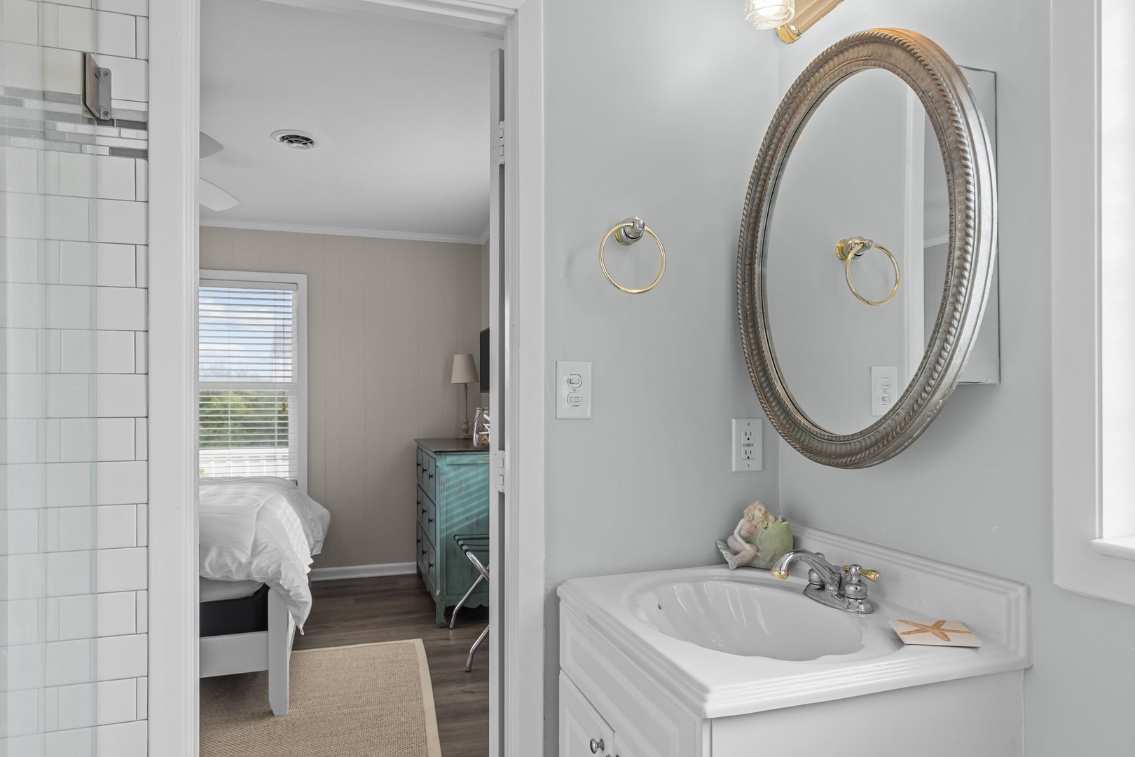 Step into your elegant ensuite bathroom with pristine white fixtures and thoughtful touches that make your morning routine feel luxurious.