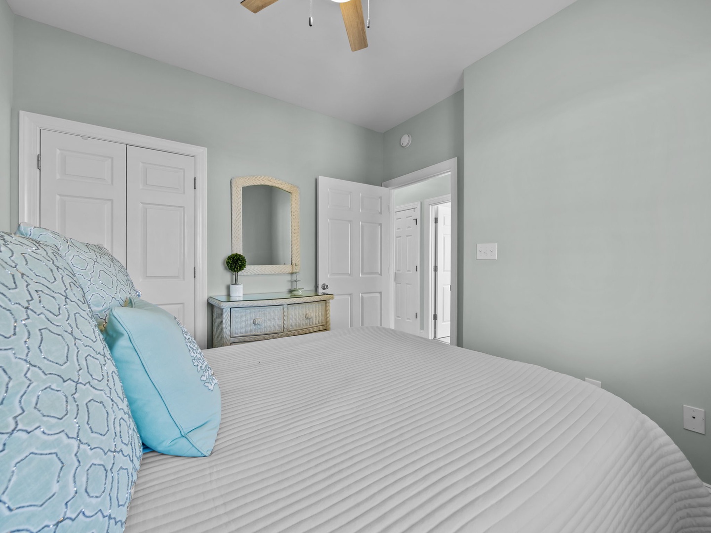 Slip into peaceful slumber surrounded by soothing sage walls and crisp linens, with thoughtful touches like the stylish floating vanity creating your perfect retreat.