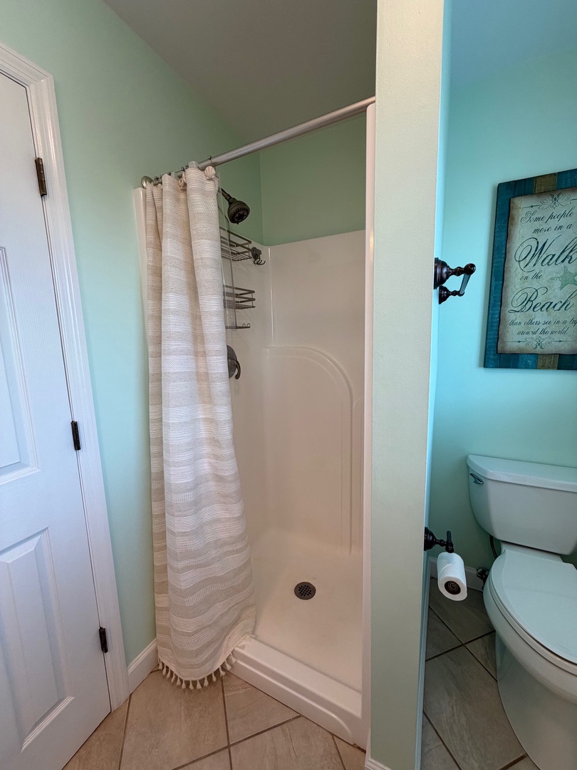 Sink into relaxation with your private soaking tub, where soft towels and soothing coastal colors create the perfect retreat.
