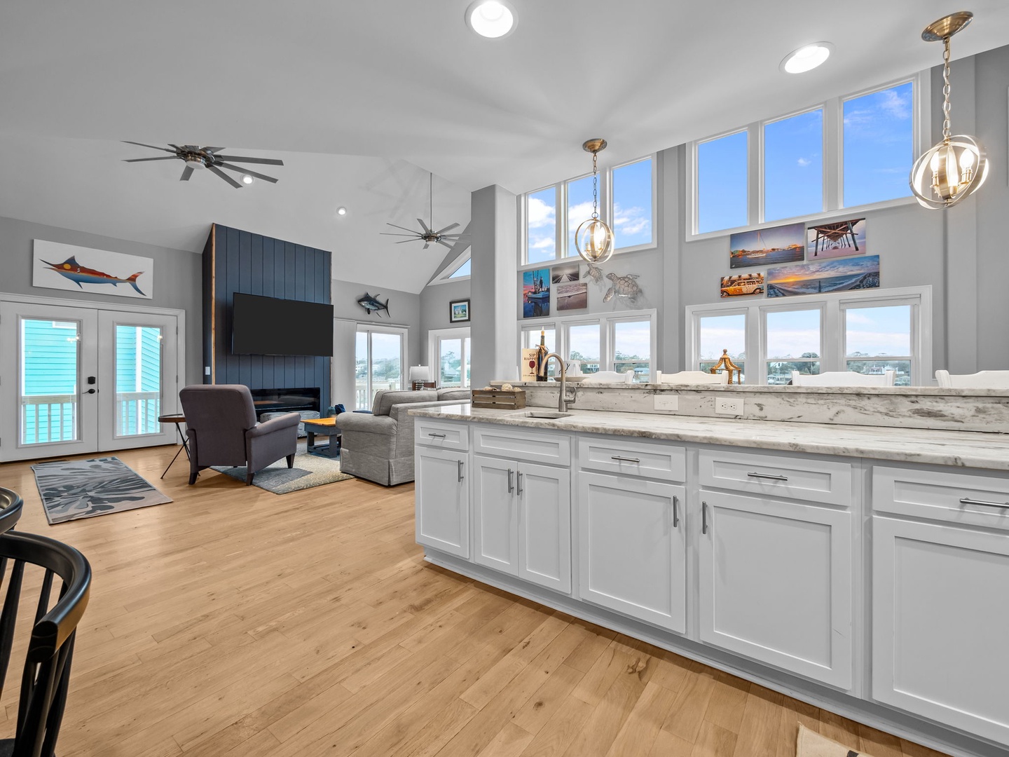 Step into your bright, open kitchen with granite counters and stunning water views through floor-to-ceiling windows.