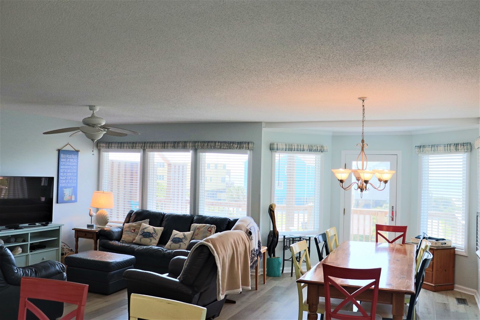 Relax in your bright open-plan living space with comfortable leather seating and stunning city views through oversized windows.