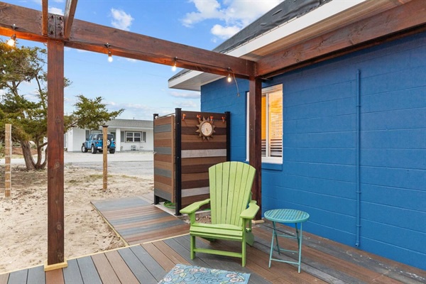 Your private beachfront retreat features a charming covered deck with colorful seating where you can unwind just steps from the sand.