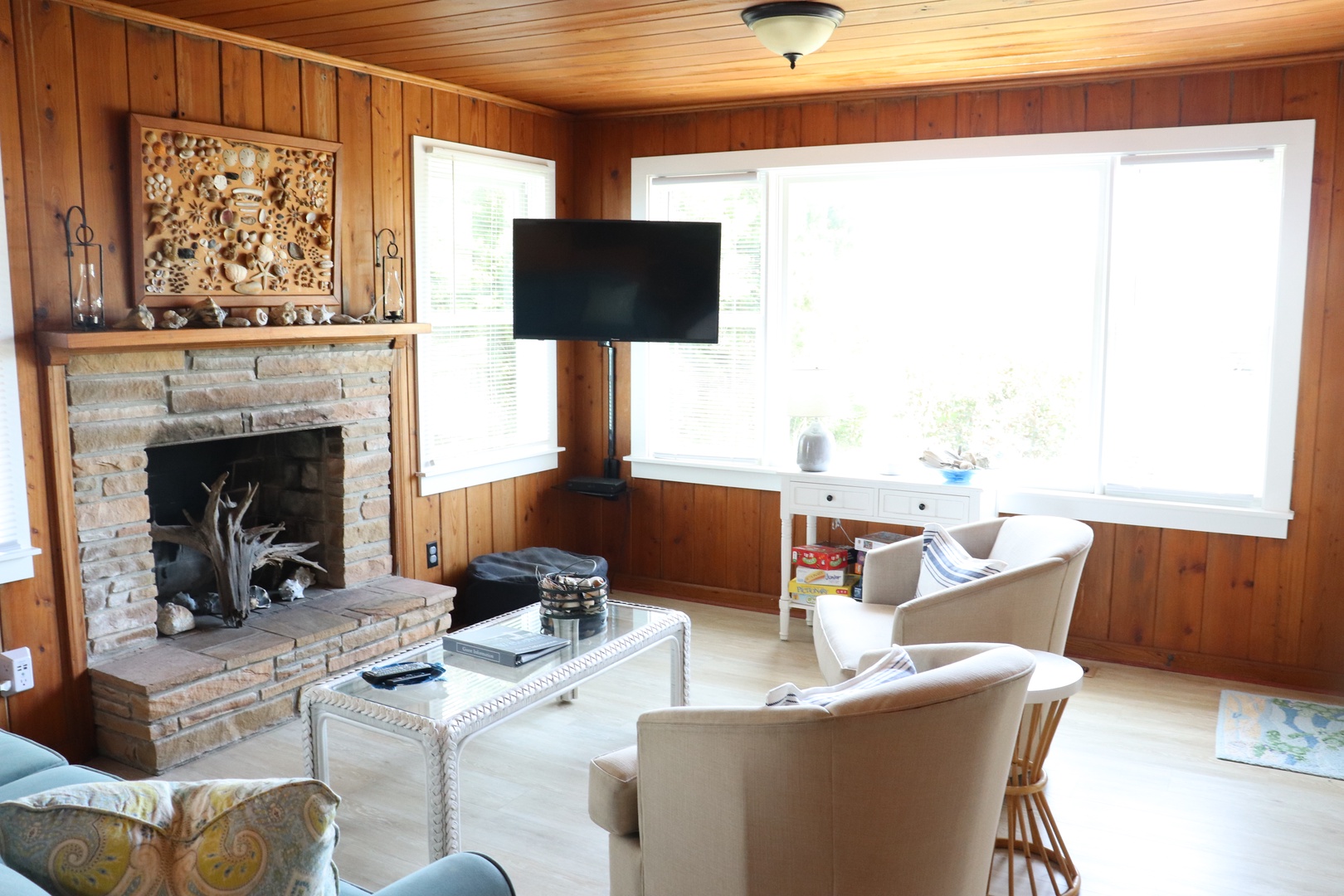 Warm wood-paneled walls surround your cozy living space, where you can curl up by the stone fireplace.