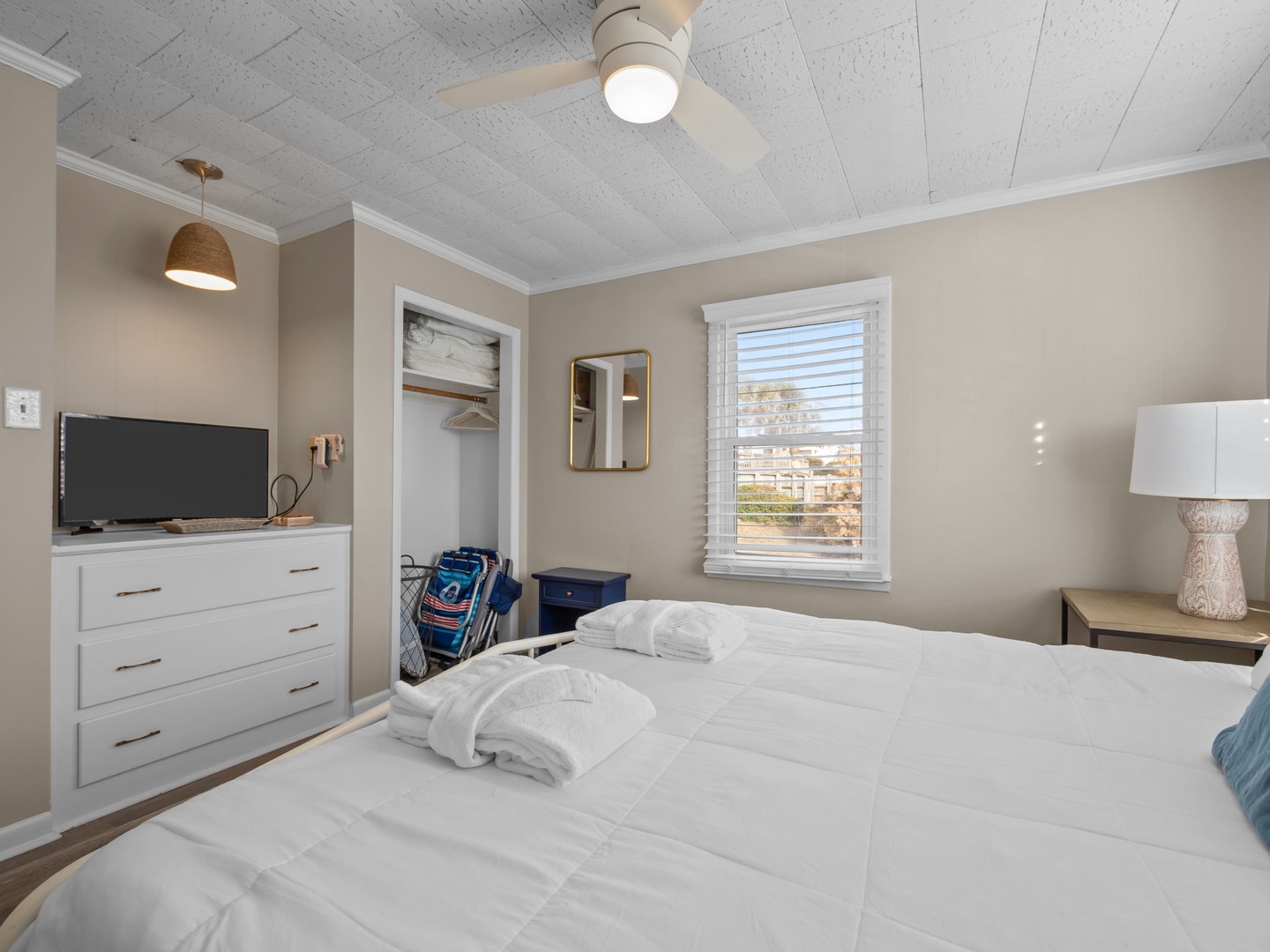 Unwind in your peaceful bedroom with soft linens, thoughtful amenities, and natural light streaming through the window.