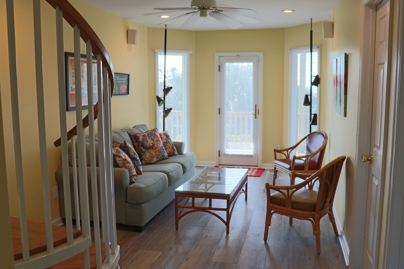 Your bright living room welcomes you with cozy seating, natural light streaming through French doors, and charming touches throughout.