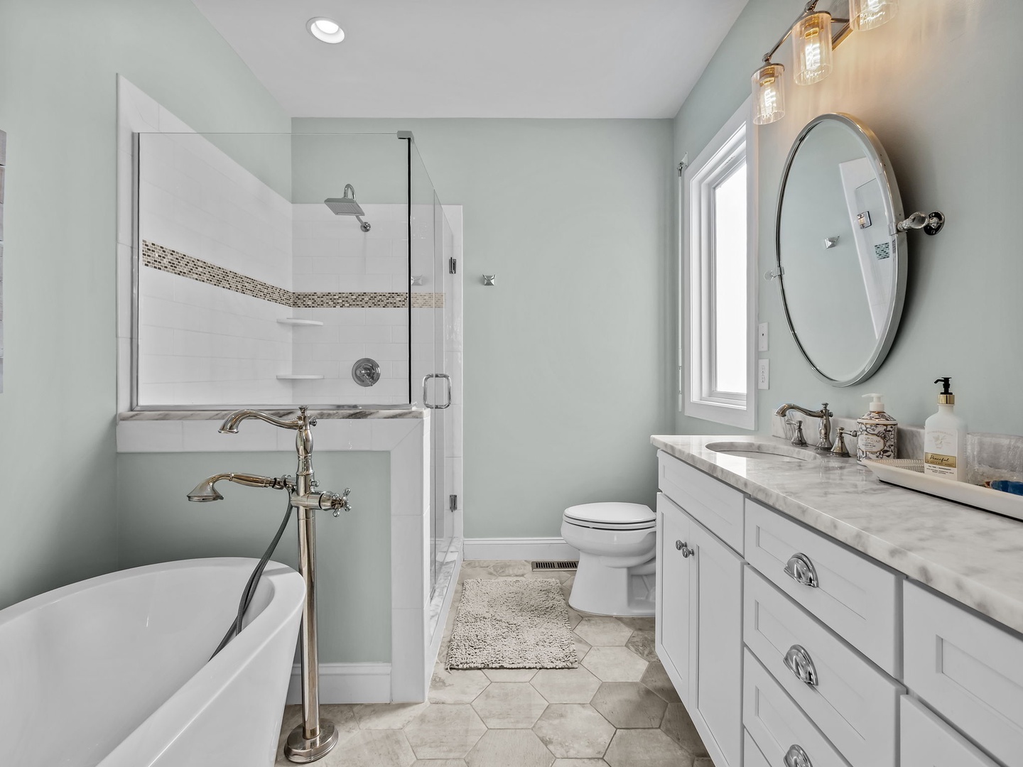 Unwind in your spa-like bathroom featuring a soaking tub, rainfall shower, and elegant marble finishes that create the perfect retreat.
