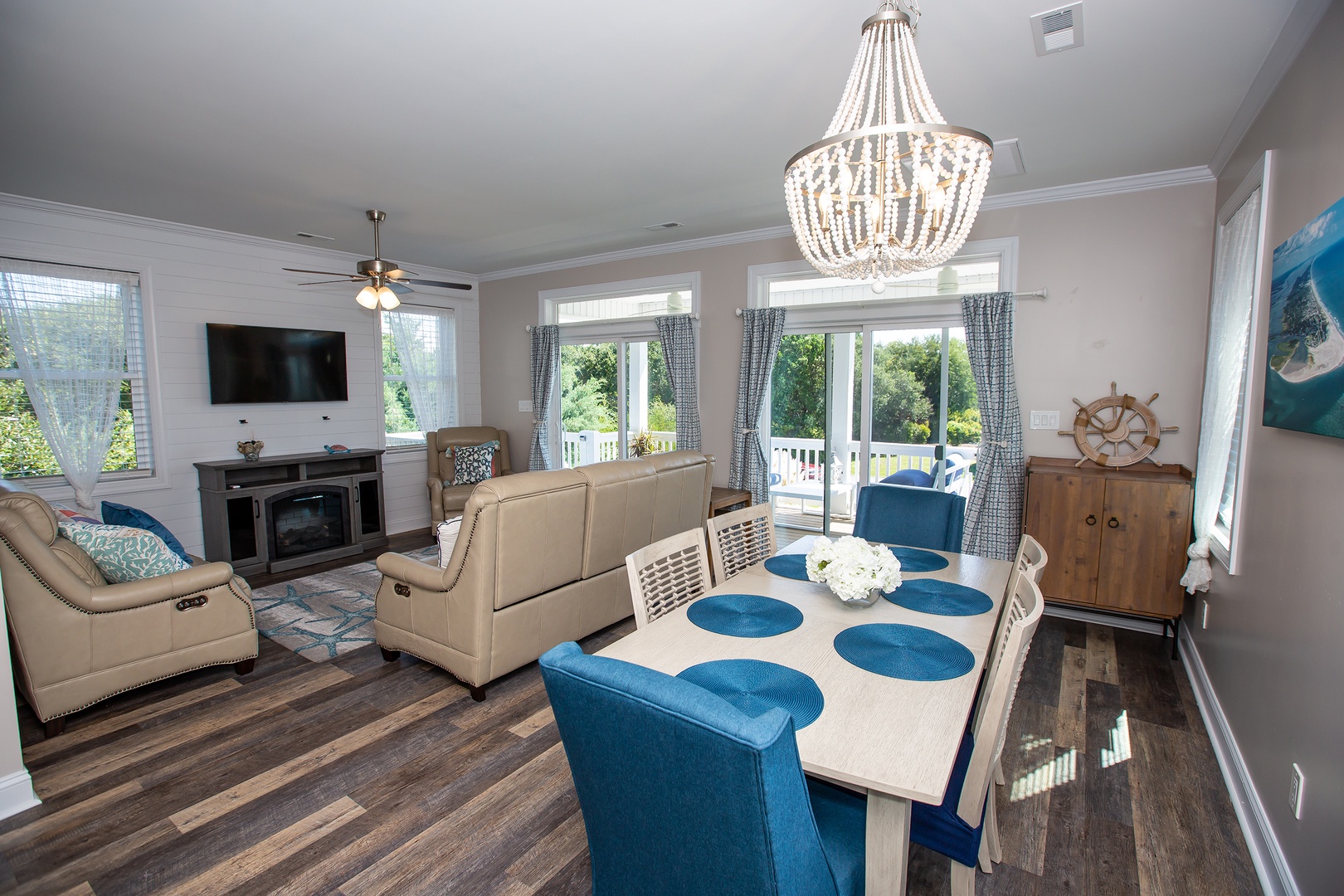 Gather around your spacious dining table where the coastal chandelier casts warm light over family meals and game nights.