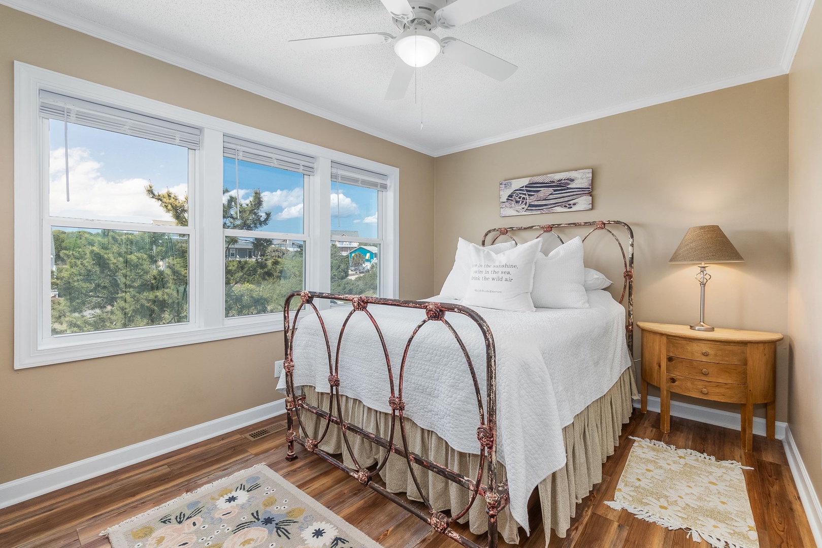 Rest peacefully in this charming bedroom with treetop views and coastal cottage touches that make your getaway feel like home.