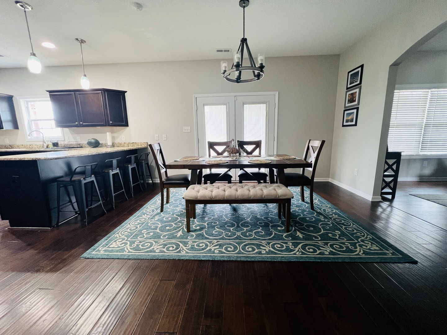 Gather around this beautiful dining table where your meals become memories, with the kitchen just steps away for easy entertaining.