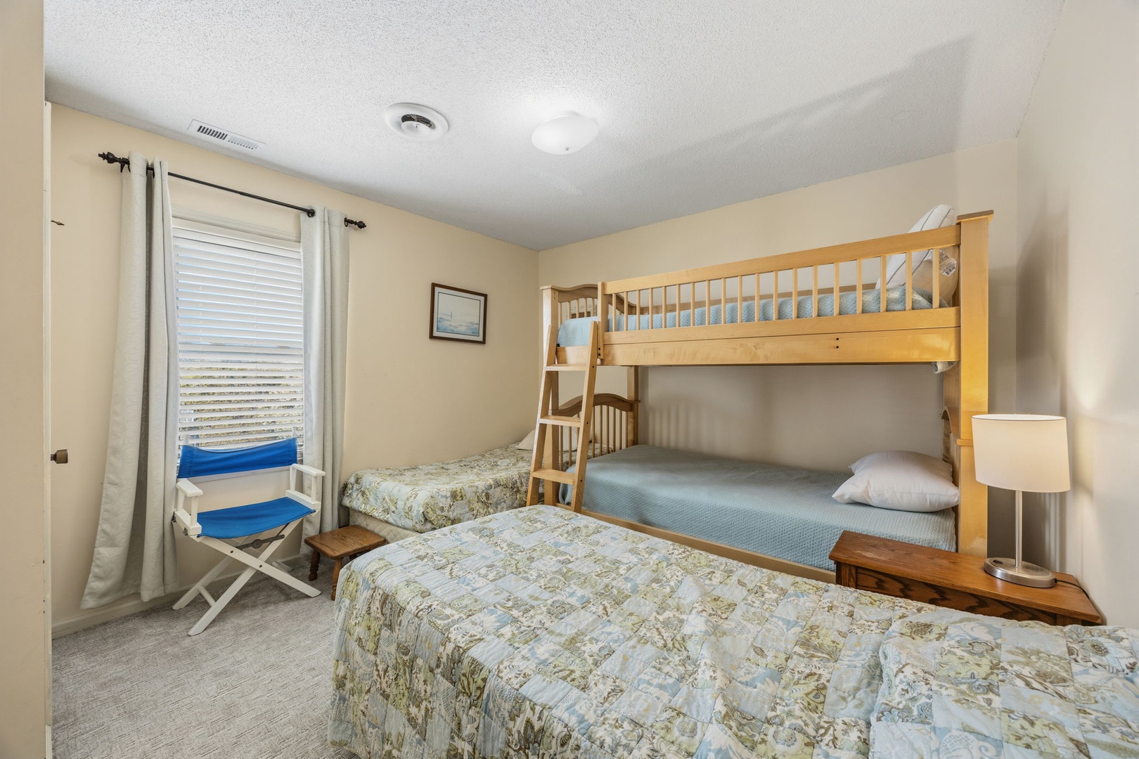 Your family's perfect sleep sanctuary features a cozy bunk bed and twin beds, ideal for creating lasting memories with loved ones.