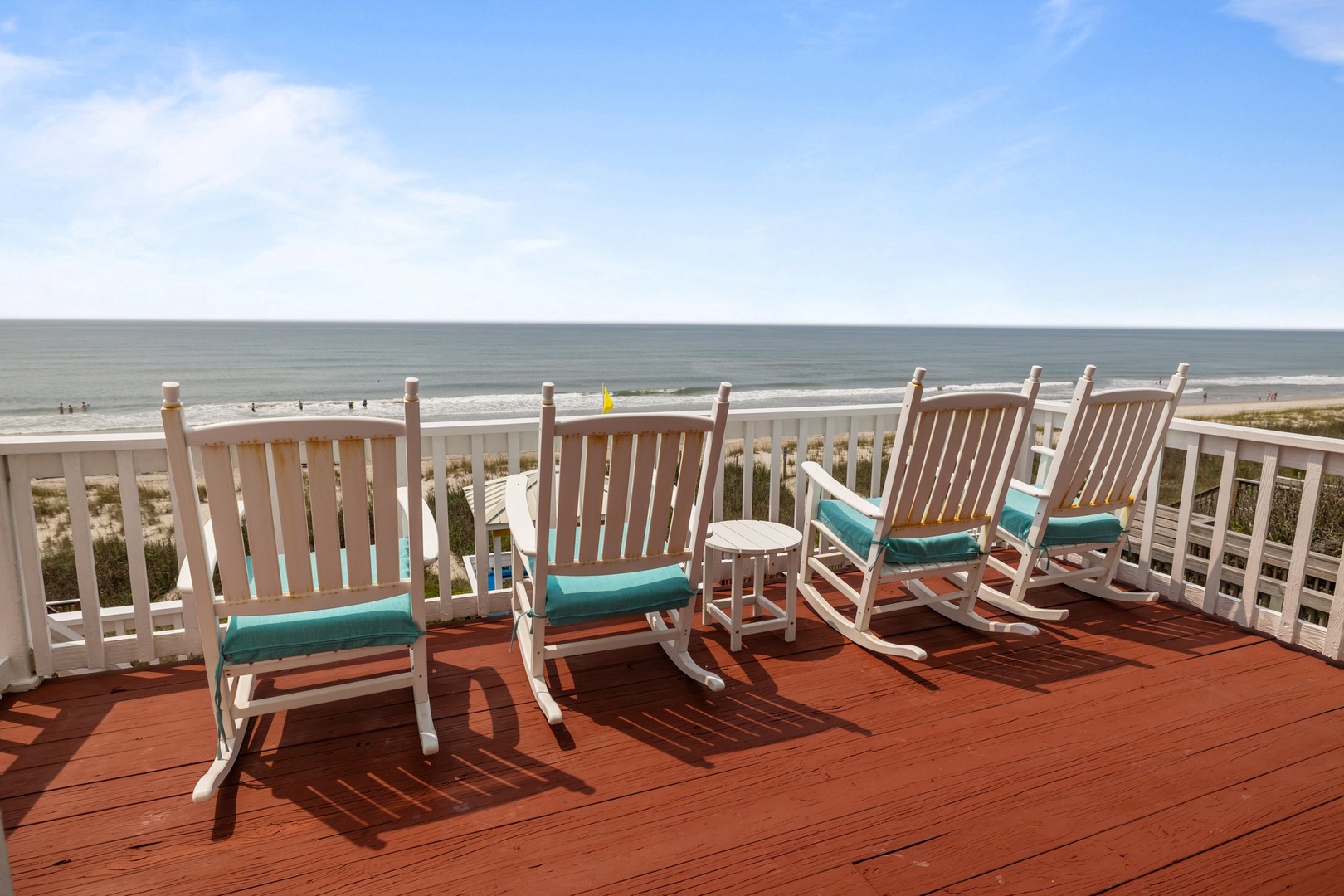 Sway gently in your rocking chair while ocean waves create the perfect soundtrack for your morning coffee or evening sunset ritual.