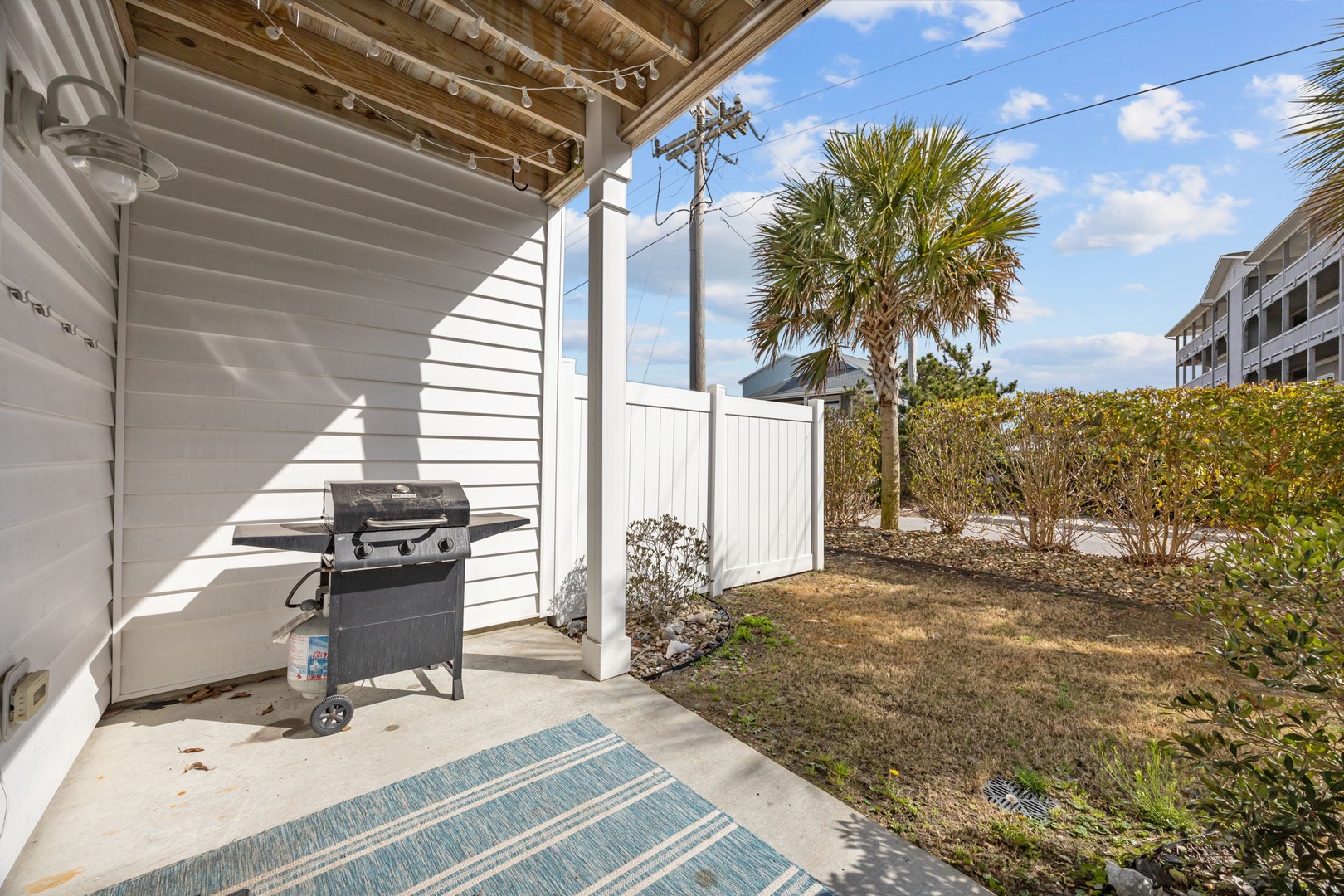 Your private covered patio awaits with a ready-to-use gas grill, perfect for outdoor dining in this tropical setting.