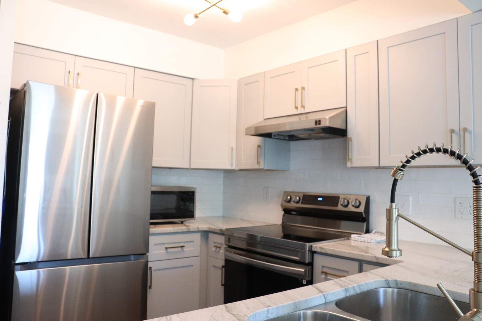 Your modern kitchen features stainless steel appliances and crisp white cabinetry, creating the perfect space for preparing meals during your stay.