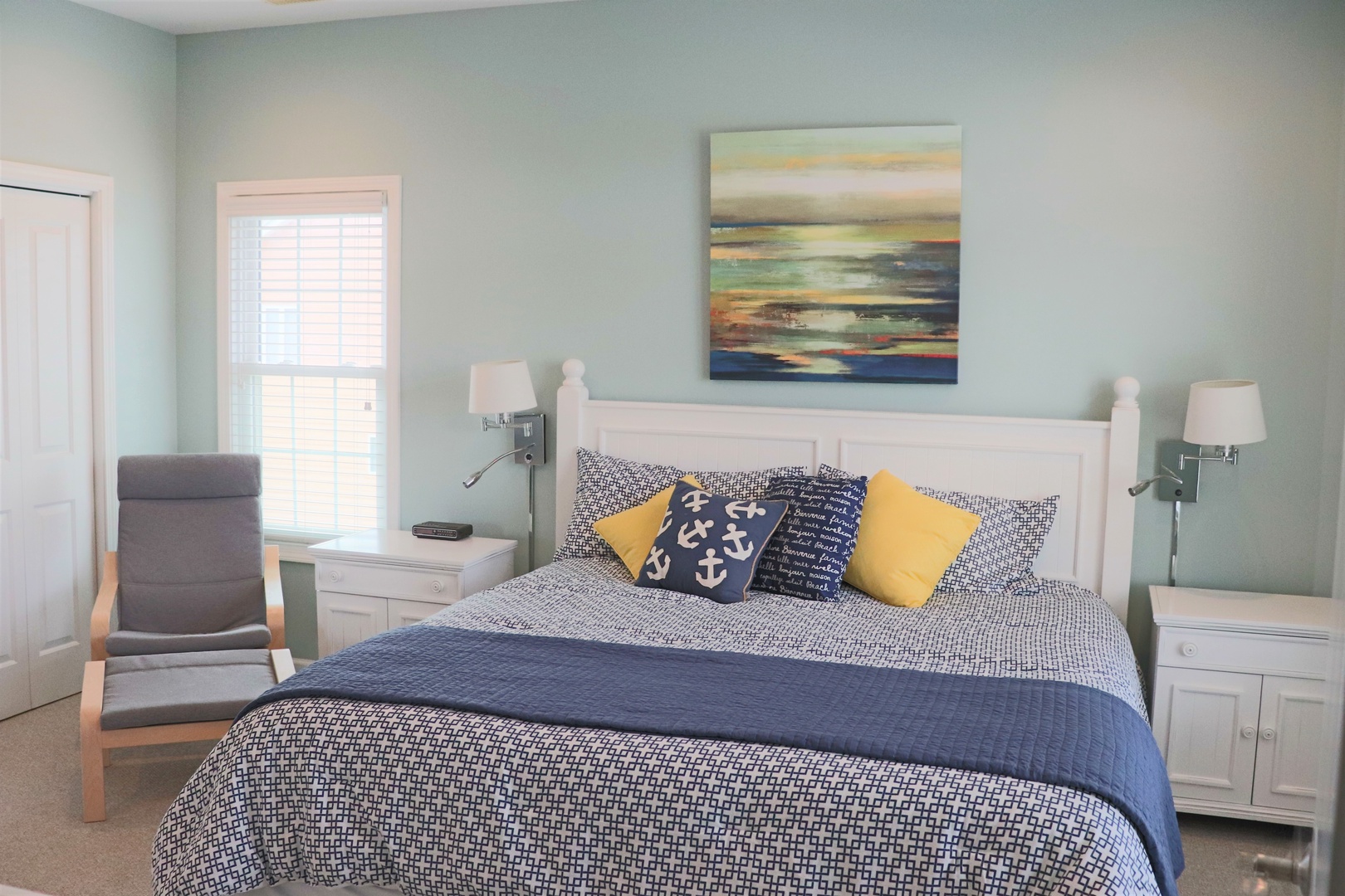 Drift off in this serene bedroom with calming coastal colors, soft linens, and peaceful artwork creating your perfect seaside retreat.