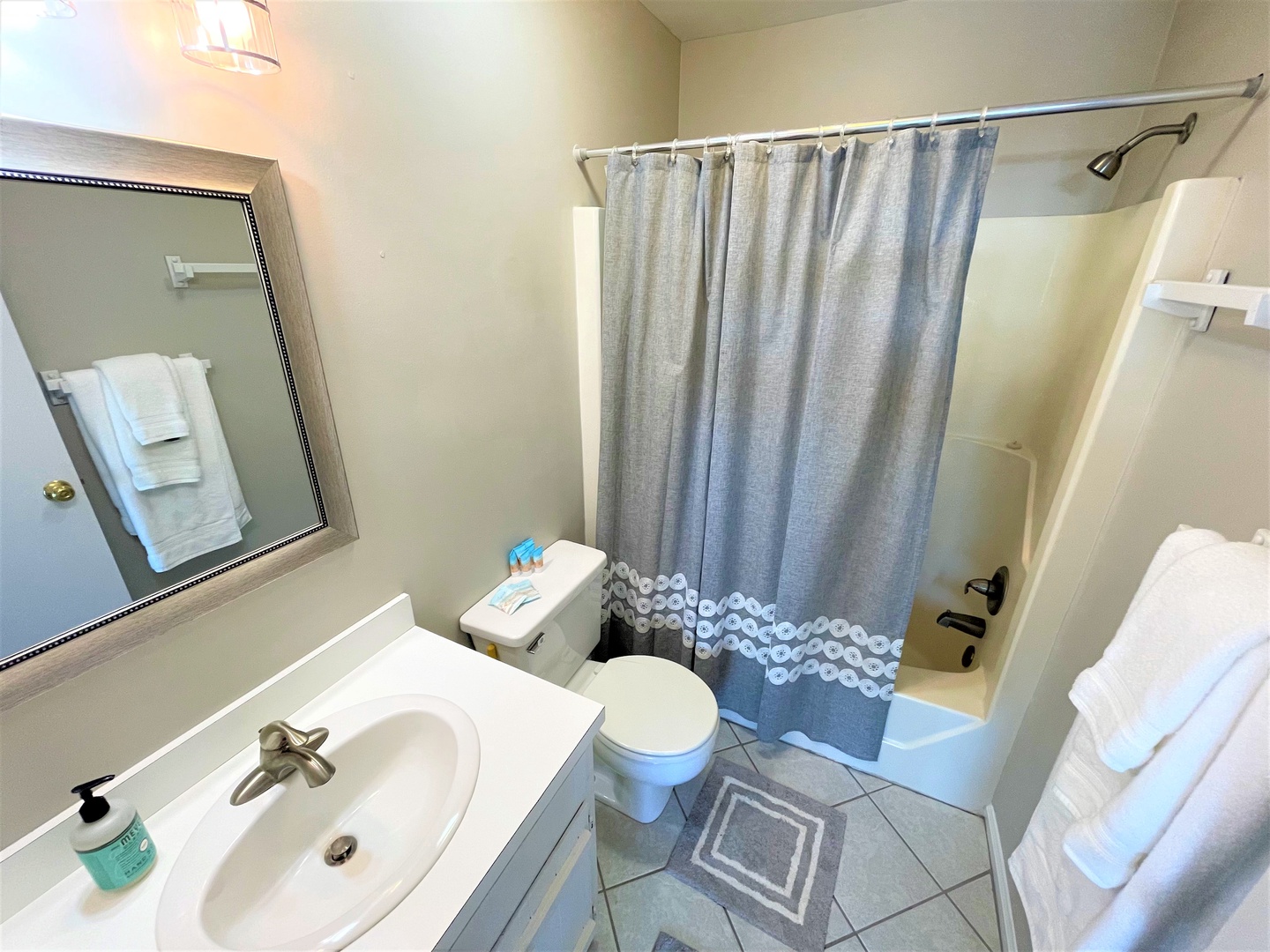 Step into your private bathroom featuring a relaxing tub, modern fixtures, and fresh towels ready for your comfort.