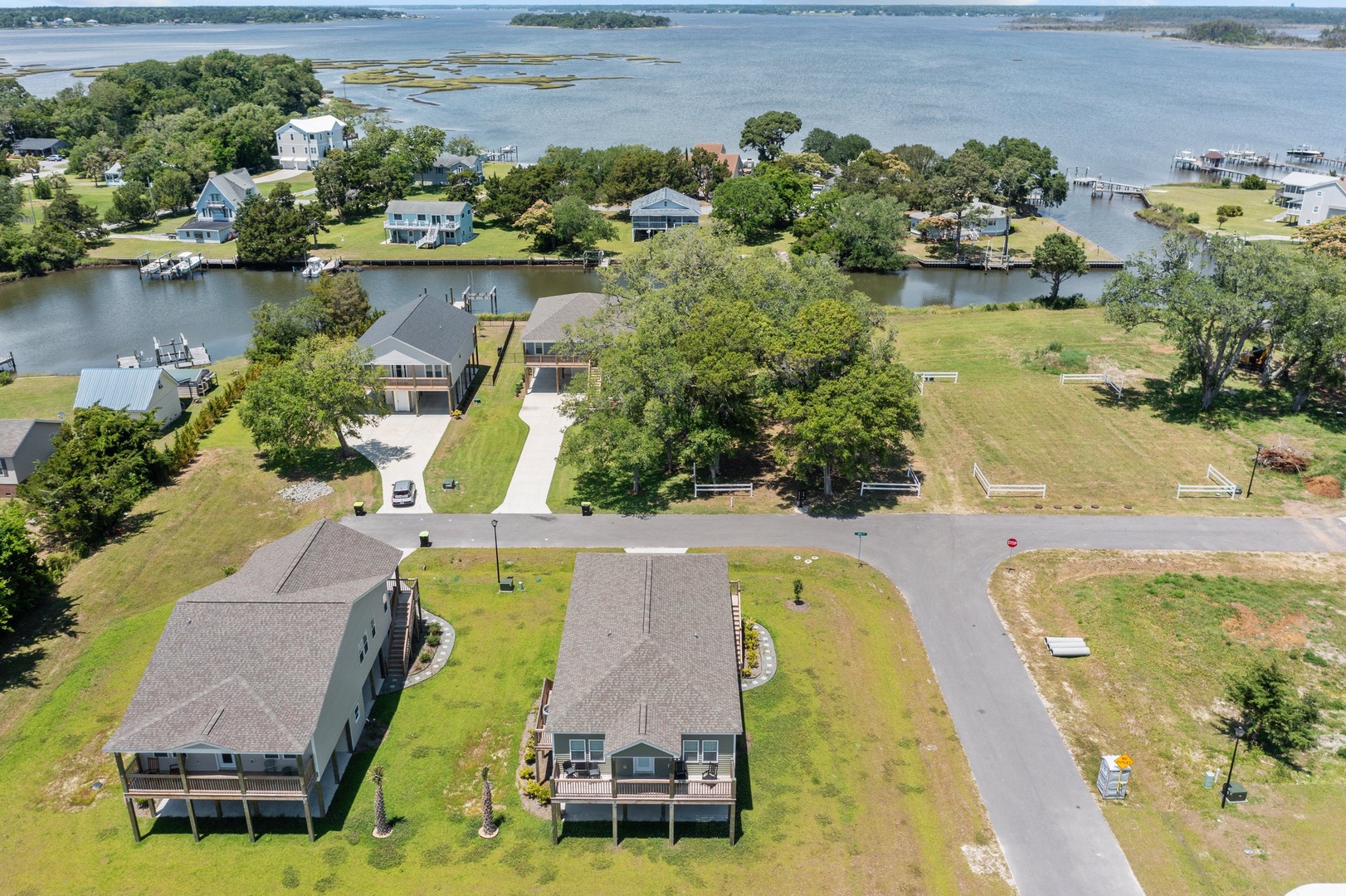 Aerial view of waterfront properties nestled along peaceful shores with private docks and easy lake access.
