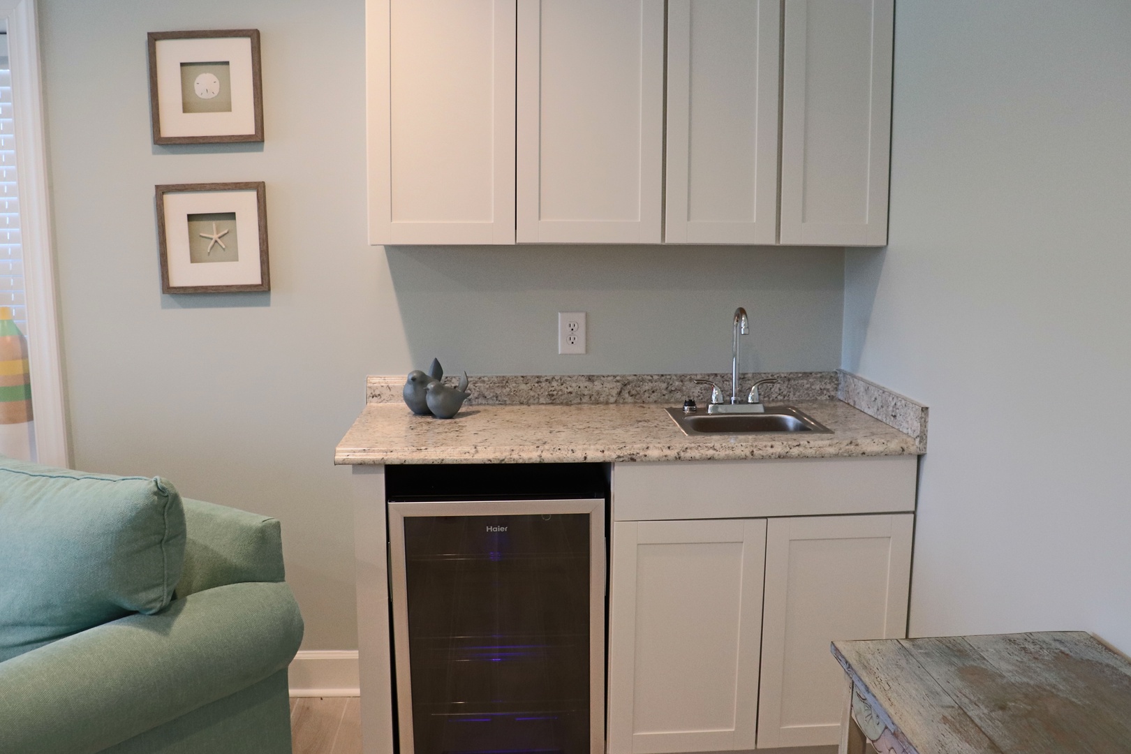 Your stylish kitchenette features granite counters, crisp white cabinetry, and a sleek wine fridge for chilled beverages after exploring.