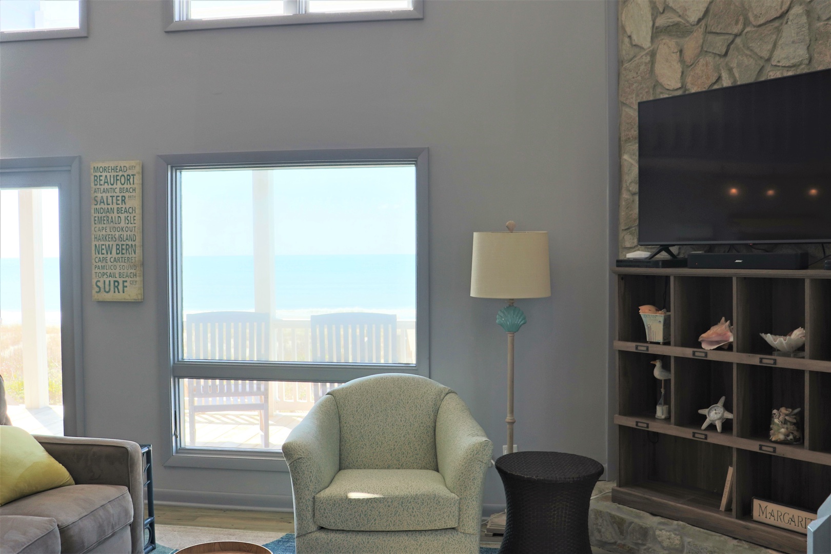 Unwind in your coastal retreat with ocean views, stone fireplace, and beach-themed decor creating the perfect seaside sanctuary.