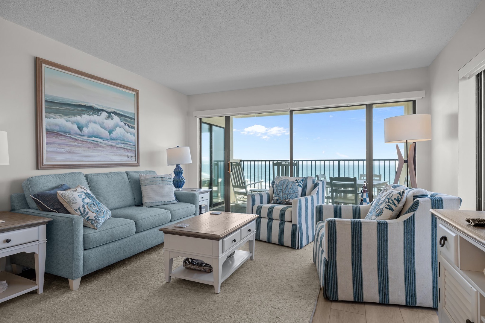 Unwind in your coastal-inspired living room where ocean blues meet comfort. Step onto your private balcony for stunning sea views.