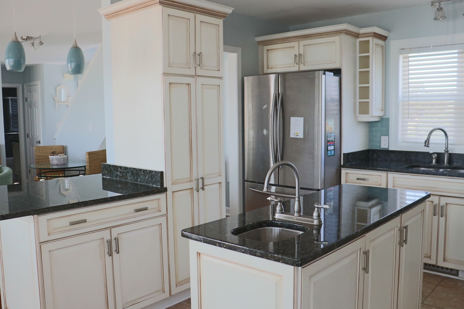 Step into this elegant kitchen with gleaming granite counters, stainless steel appliances, and custom cabinetry perfect for your culinary adventures.